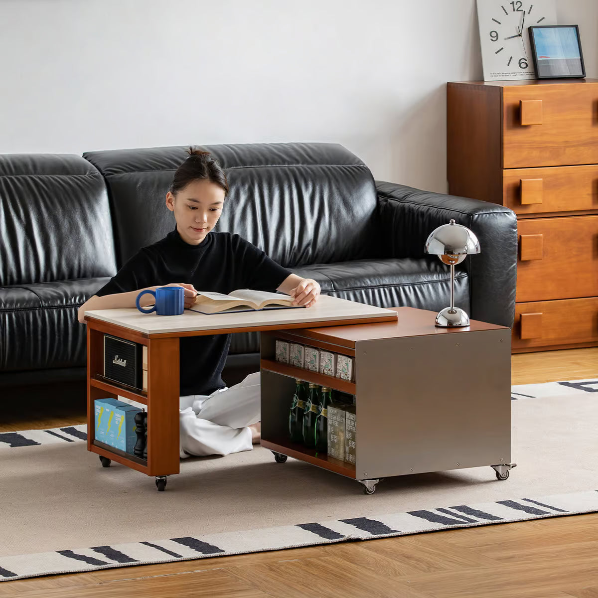 Coffee table on casters with two open storage shelves holding bottles and boxes