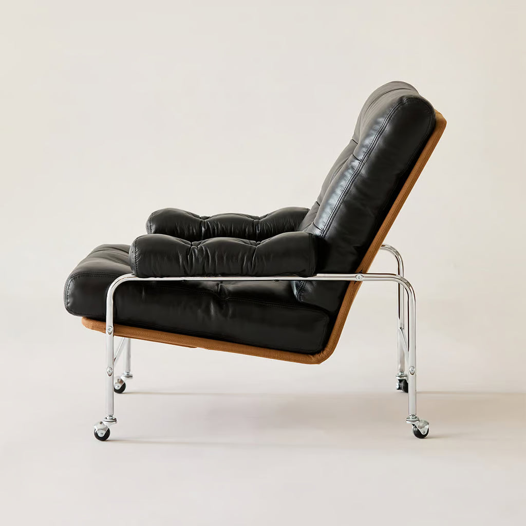 Mid century modern lounge chair on a stainless steel frame with casters