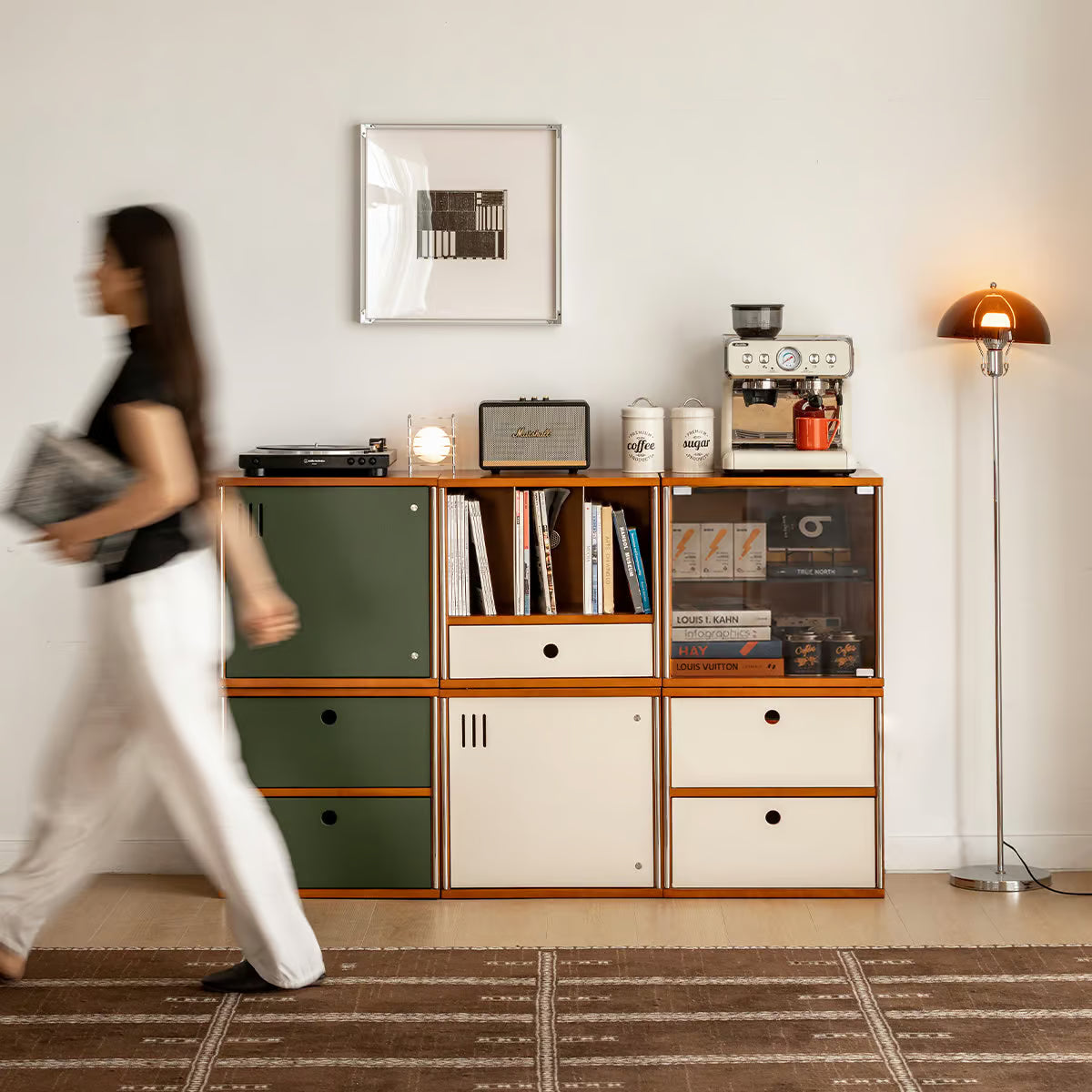 Mid century modular storage units stacked two high in a living room with a coffee machine and lamp