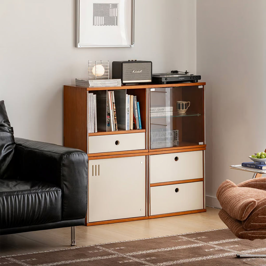 Modular record storage cabinet with glass door and turntable on top beside a black leather sofa