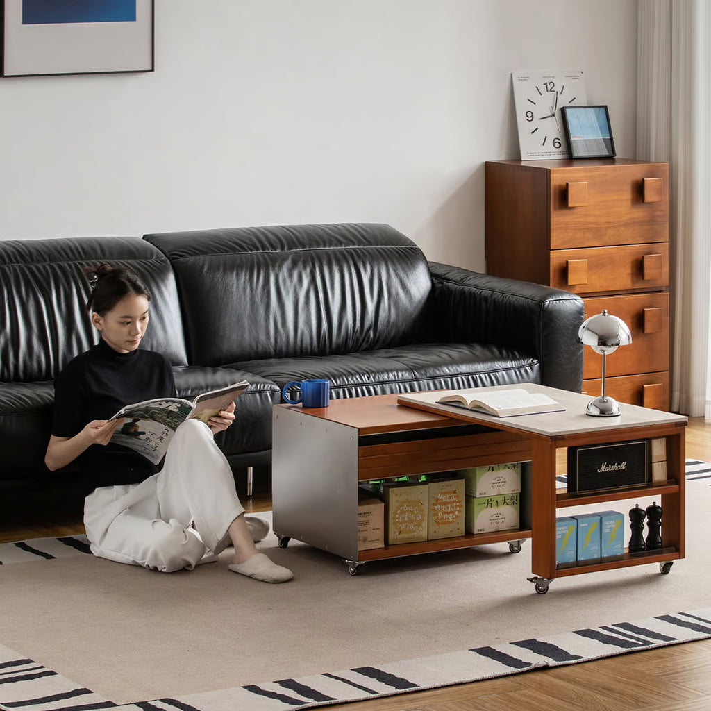 Woman reading on the floor beside a coffee table