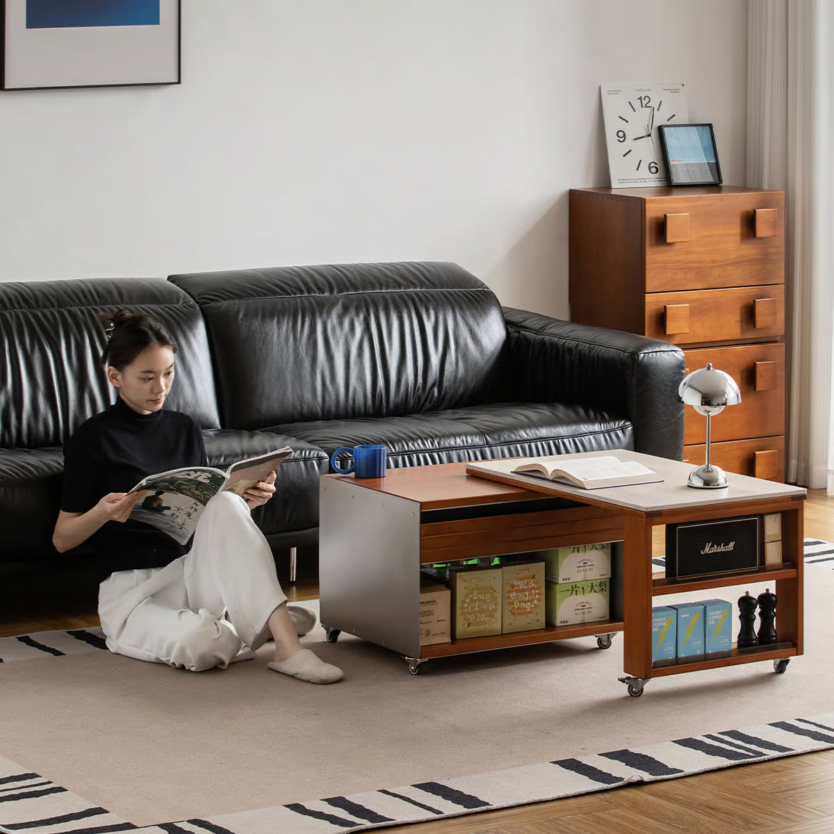 Woman reading on the floor beside a coffee table